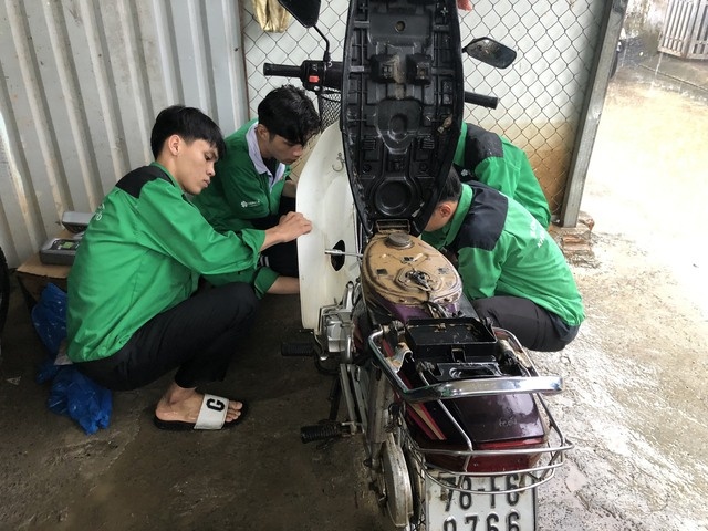 Đội sinh viên trường Đại học Đông Á sửa xe miễn phí cho người dân vùng rốn lũ - Ảnh: VGP/Minh Trang