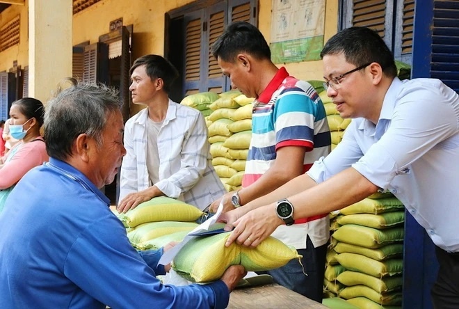 Người dân đến nhận gạo, một phần trong suất tặng phẩm của chương trình. (Ảnh: Quang Anh/TTXVN)