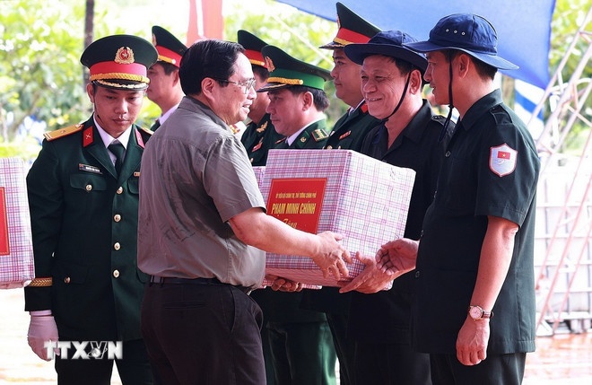 Thủ tướng Phạm Minh Chính tặng quà các Đội tìm kiếm, quy tập hài cốt liệt sỹ. (Ảnh: TTXVN) Thủ tướng Phạm Minh Chính tặng quà các Đội tìm kiếm, quy tập hài cốt liệt sỹ. (Ảnh: TTXVN)